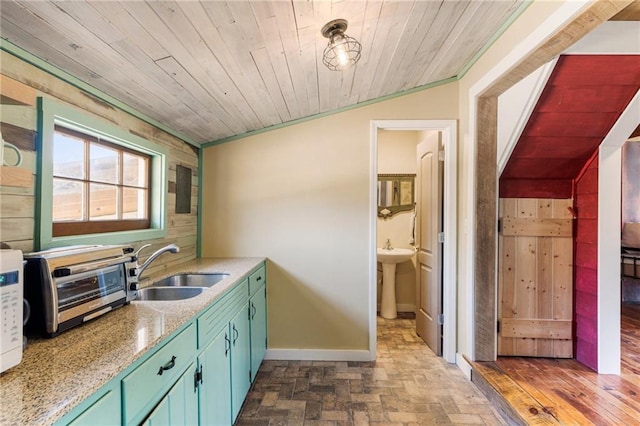 kitchen featuring baseboards, wood ceiling, a toaster, and a sink