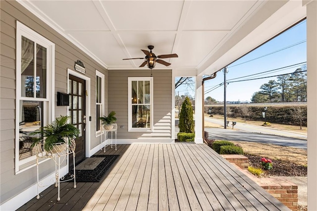 wooden terrace with a ceiling fan