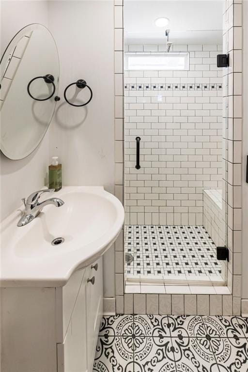 bathroom featuring a stall shower, tile patterned flooring, and vanity