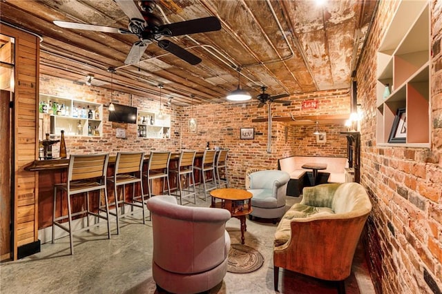 interior space featuring brick wall, a bar, wooden ceiling, and a ceiling fan