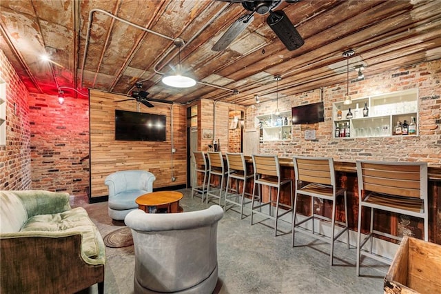 interior space featuring a dry bar, brick wall, wood ceiling, and ceiling fan