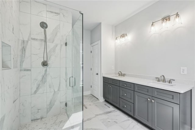 full bathroom with a marble finish shower, marble finish floor, double vanity, and a sink