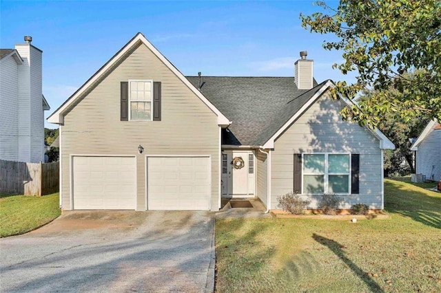 view of front of property featuring a front yard and a garage