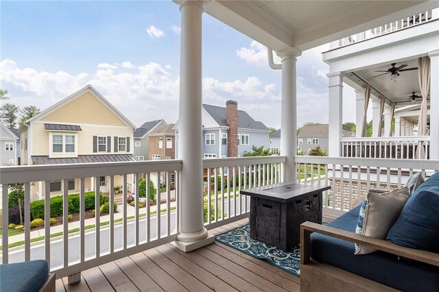 deck featuring a ceiling fan and a residential view