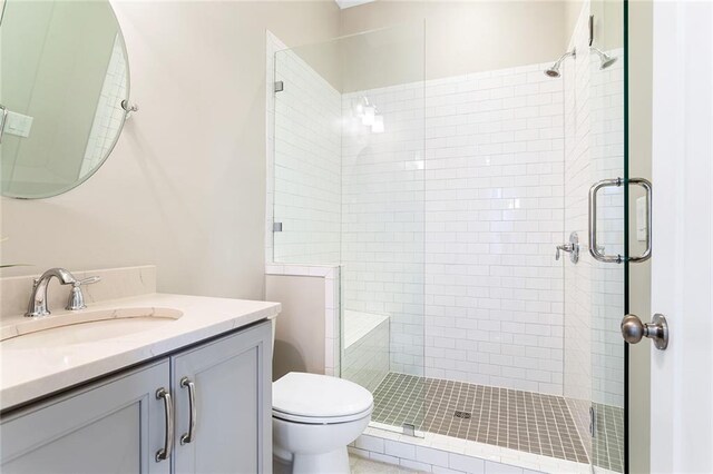 full bath with toilet, a shower stall, and vanity