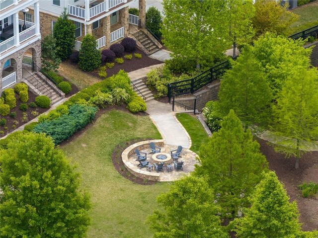view of home's community featuring stairs and a fire pit