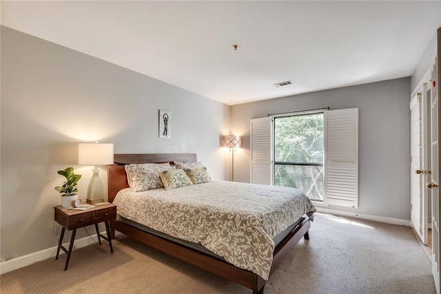 bedroom with baseboards and carpet