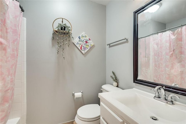 bathroom featuring curtained shower, toilet, and vanity