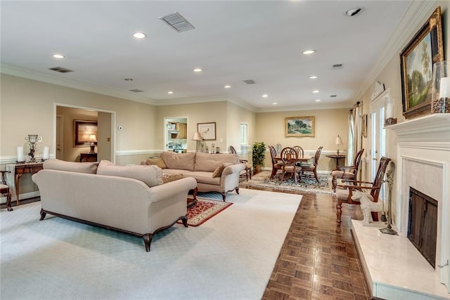 living room featuring recessed lighting, ornamental molding, a high end fireplace, and baseboards
