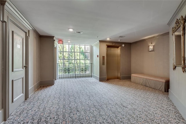 spare room with elevator, carpet, baseboards, crown molding, and recessed lighting