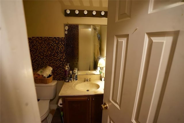 2726 Evans Mill Dr, Lithonia, GA 30058 - bathroom featuring tile walls, toilet, and vanity