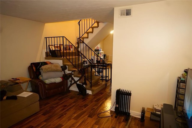 2726 Evans Mill Dr, Lithonia, GA 30058 - living area with radiator, wood finished floors, and stairs