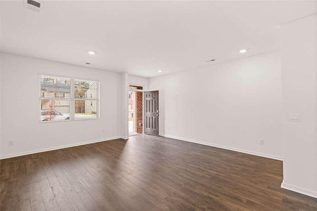 unfurnished room with dark wood-type flooring