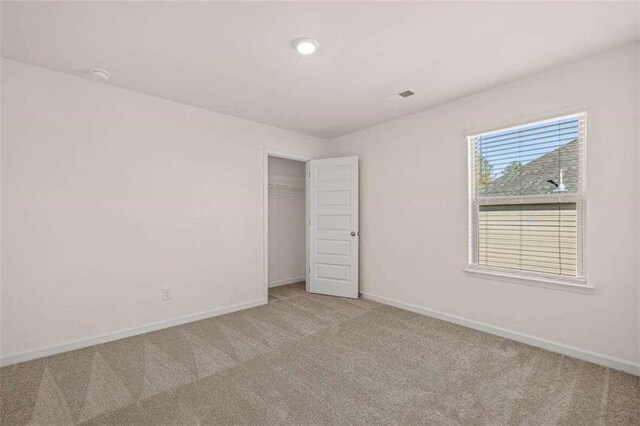 unfurnished room with light carpet