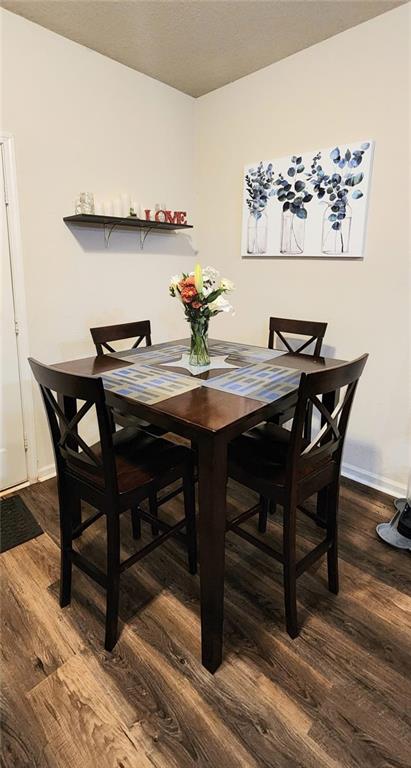 dining area featuring dark wood-type flooring