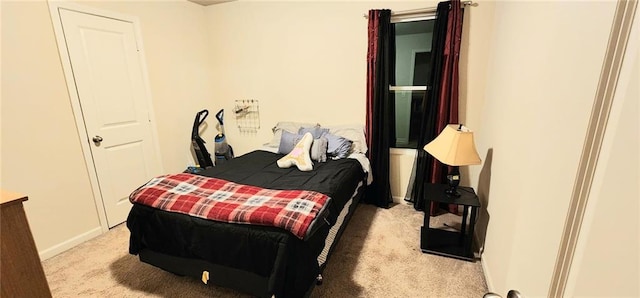 bedroom featuring light colored carpet