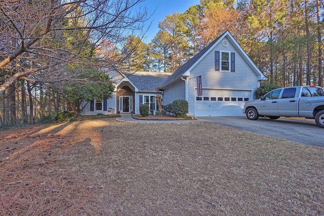 traditional-style house featuring concrete driveway and an attached garage