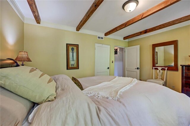 bedroom featuring ornamental molding and beamed ceiling