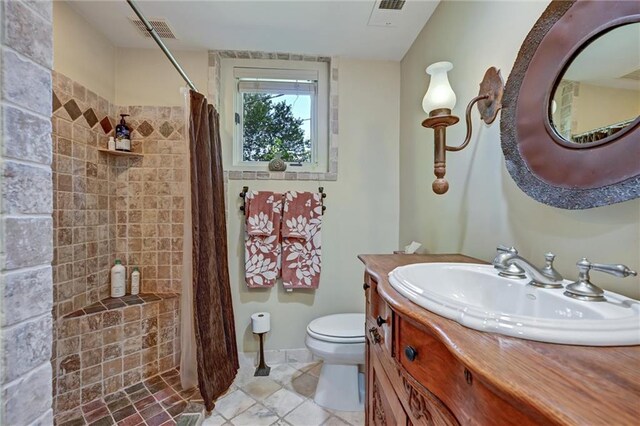 bathroom featuring vanity, toilet, tile patterned flooring, and a shower with shower curtain