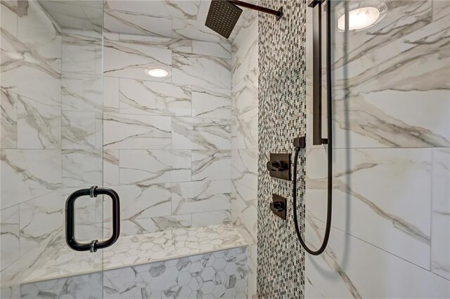 bathroom featuring a shower with shower door