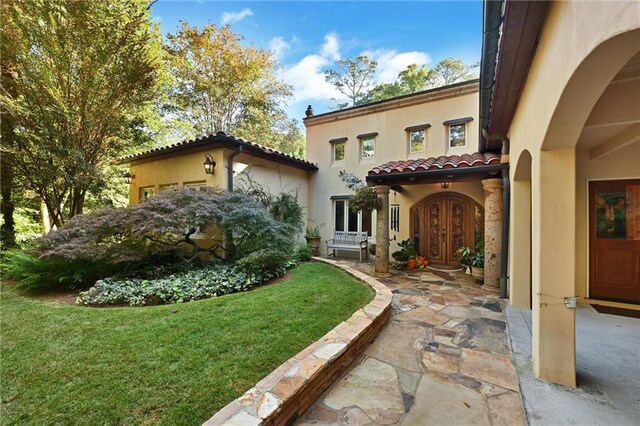 exterior space featuring a patio and a front lawn