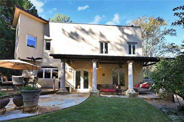 rear view of house with french doors, a yard, an outdoor hangout area, a patio area, and ceiling fan