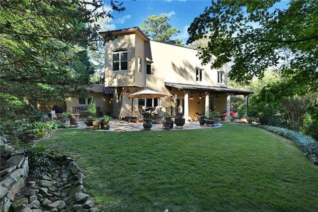 back of house featuring a patio and a lawn