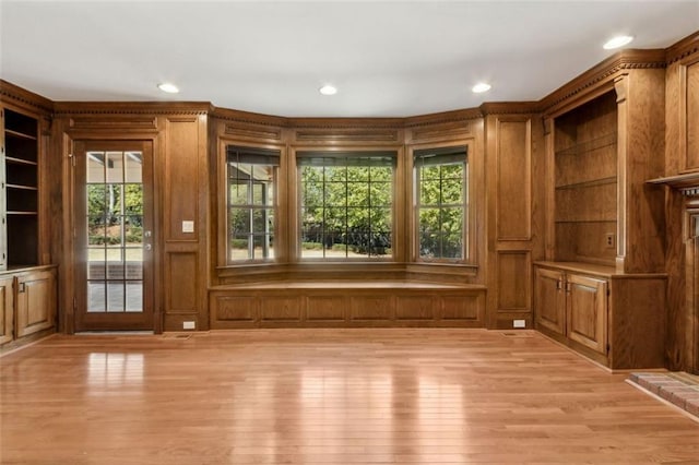 interior space with recessed lighting, light wood-style floors, and a decorative wall