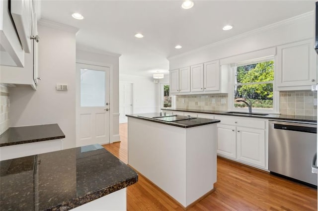 kitchen with white cabinetry, light wood finished floors, a sink, stainless steel dishwasher, and crown molding