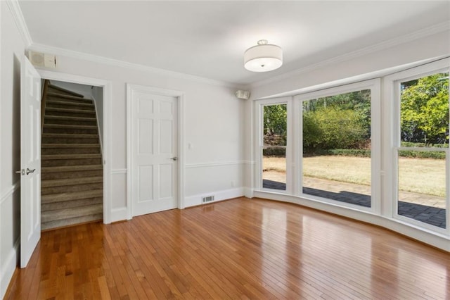 interior space with visible vents, ornamental molding, stairs, and hardwood / wood-style flooring