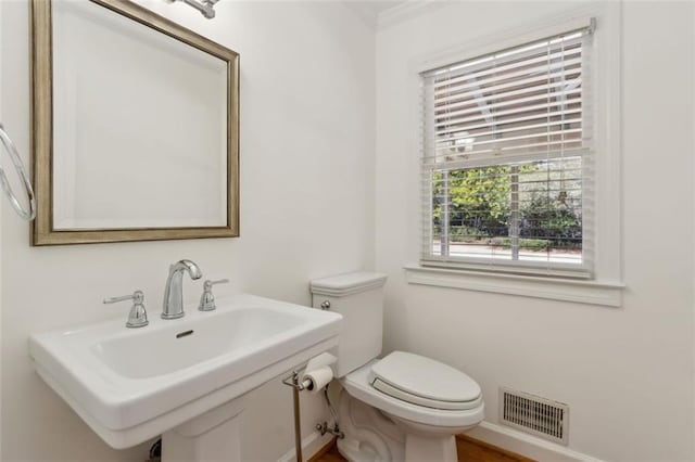 bathroom featuring a sink, visible vents, and toilet