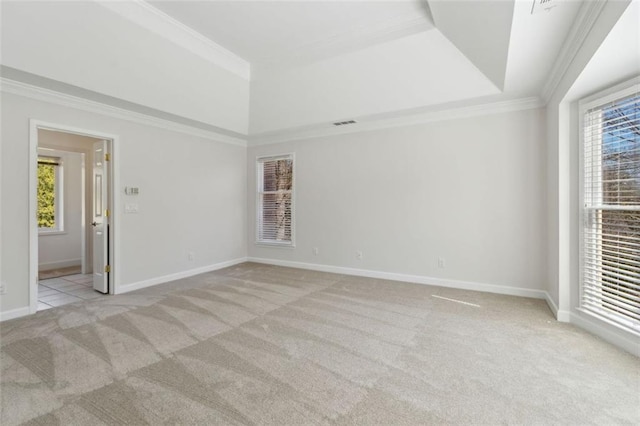 spare room with plenty of natural light, light colored carpet, baseboards, and ornamental molding