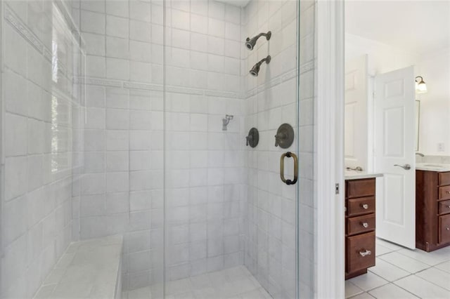 full bath featuring vanity, a shower stall, and tile patterned floors