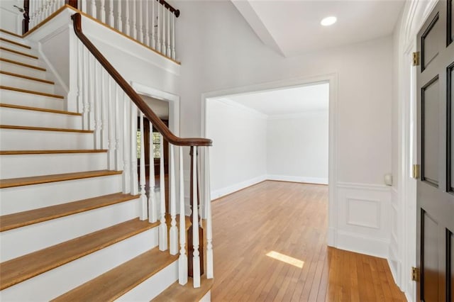 staircase with recessed lighting, baseboards, and wood-type flooring