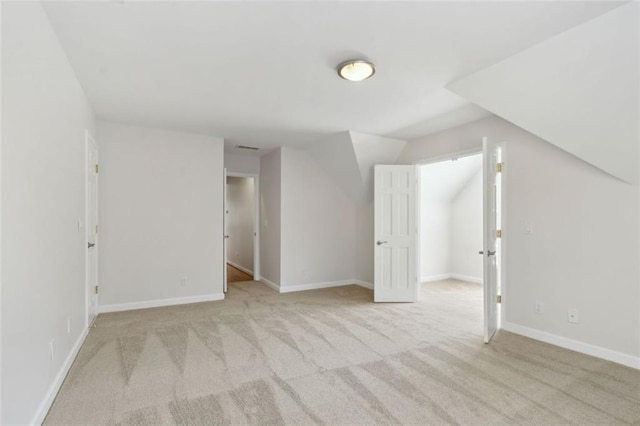 bonus room with baseboards, carpet floors, lofted ceiling, and visible vents