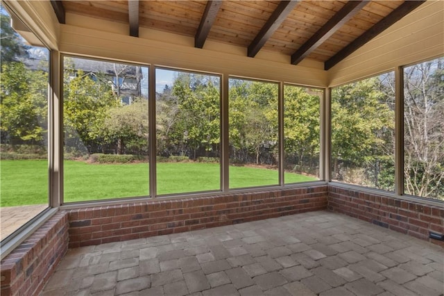 unfurnished sunroom with lofted ceiling with beams and wooden ceiling