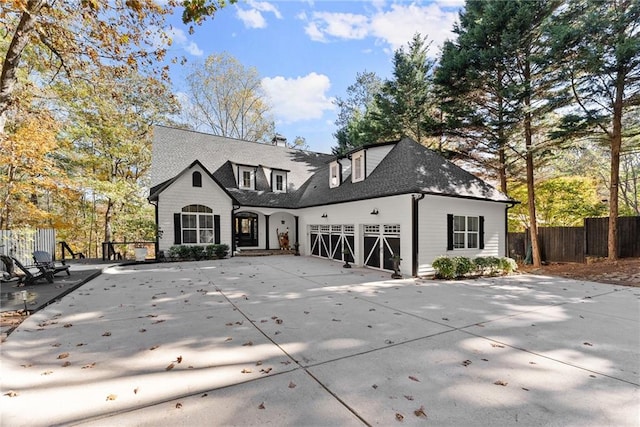 rear view of property featuring a garage