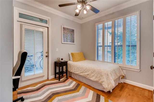 bedroom with hardwood / wood-style flooring, crown molding, and ceiling fan