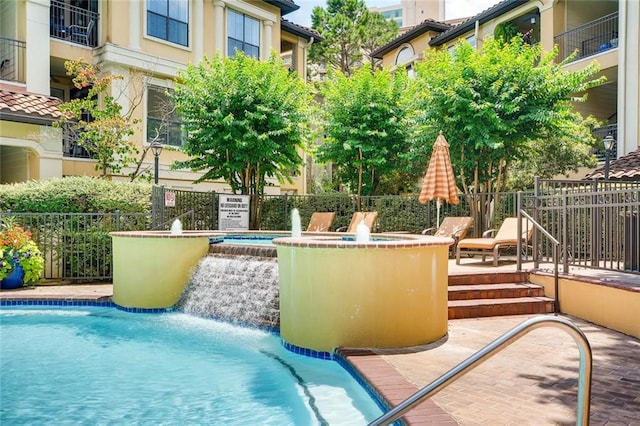 view of swimming pool with pool water feature