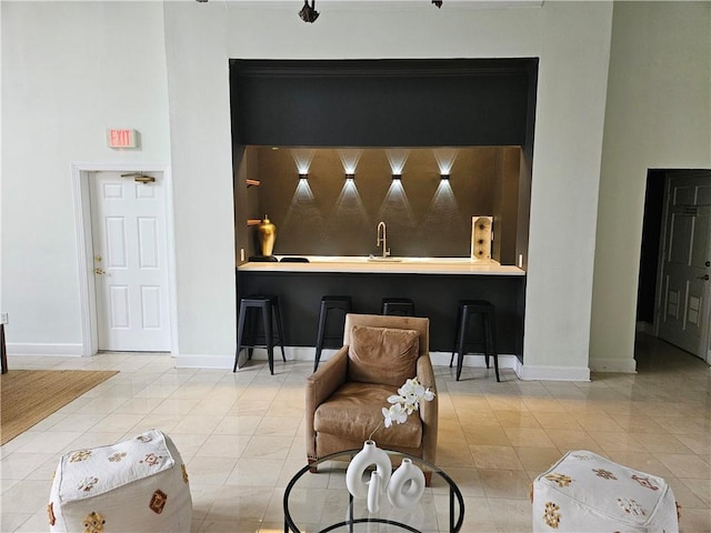 bar with sink and light tile patterned floors