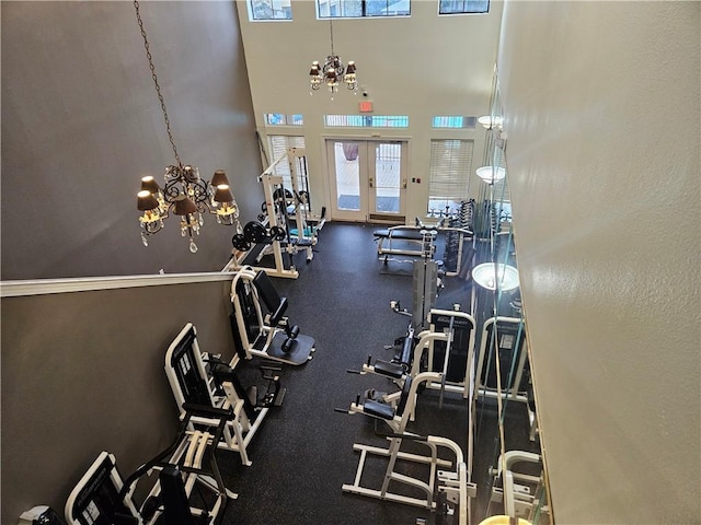 workout area with an inviting chandelier and french doors