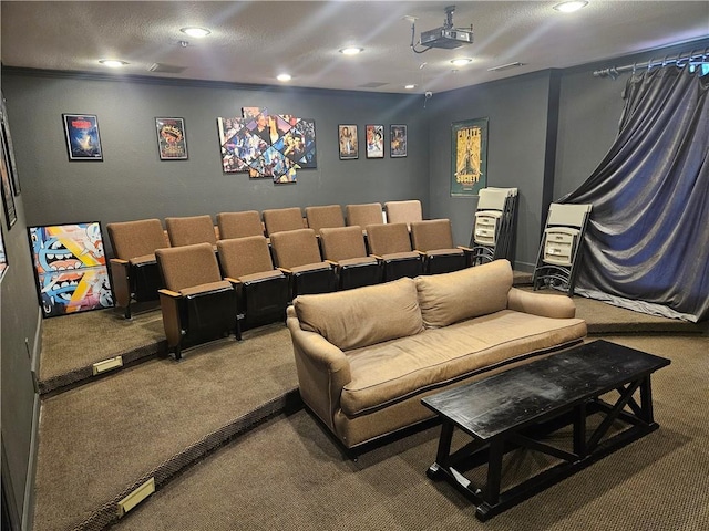 carpeted home theater room with ornamental molding and a textured ceiling