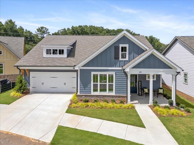 craftsman-style house featuring a front yard, a garage, and a porch