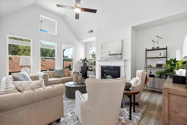 living room with ceiling fan, high vaulted ceiling, and hardwood / wood-style floors