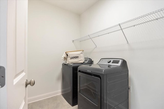 clothes washing area featuring washer and dryer