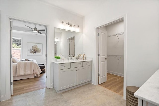 bathroom featuring hardwood / wood-style flooring, ceiling fan, and vanity