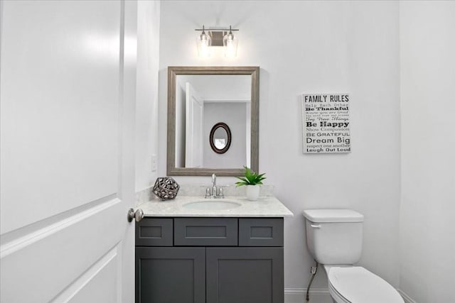 bathroom featuring toilet and vanity