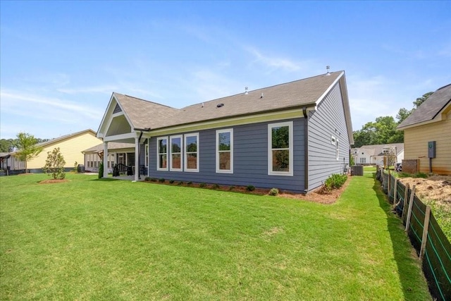 rear view of house with a lawn