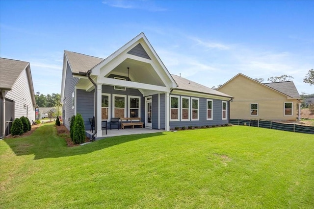 rear view of house featuring a patio area and a lawn