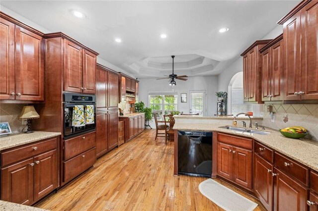 kitchen with black appliances, a sink, arched walkways, a ceiling fan, and recessed lighting